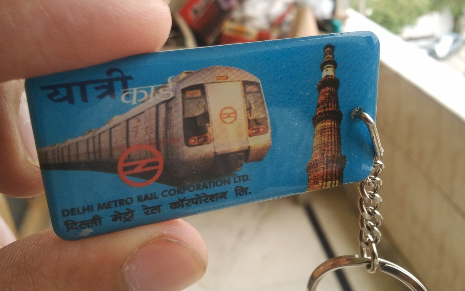 Delhi Metro smart card in key-fob form, with the DMRC logo and the Qutub Minar
